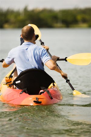 simsearch:625-00801301,k - Rear view of a young man kayaking in a lake Stock Photo - Premium Royalty-Free, Code: 625-00900159