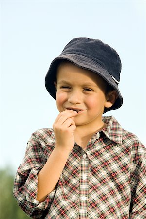 Close-up of a boy eating a chocolate Stock Photo - Premium Royalty-Free, Code: 625-00900263