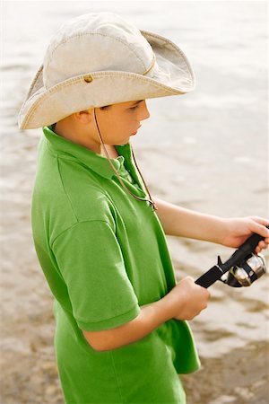 photos of little boy fishing - High angle view of a teenage boy fishing in a lake Foto de stock - Sin royalties Premium, Código: 625-00900734