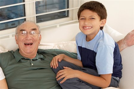 simsearch:400-06142278,k - Portrait of a boy sitting with his grandfather on a couch Stock Photo - Premium Royalty-Free, Code: 625-00901089