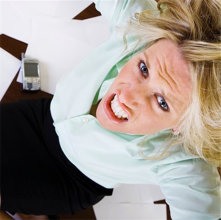 simsearch:625-00801205,k - High angle view of a young woman clenching her teeth Stock Photo - Premium Royalty-Free, Code: 625-00901365