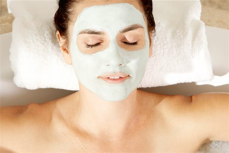 High angle view of a young woman with a facial mask relaxing in a bathtub Stock Photo - Premium Royalty-Free, Code: 625-00901586