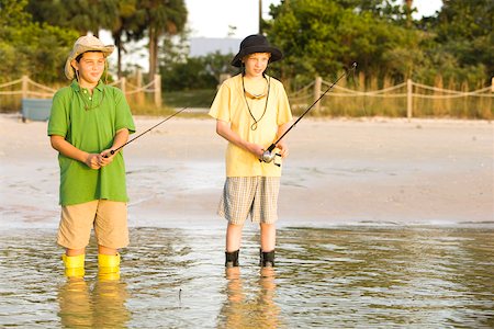 Two boys fishing in a lake Stock Photo - Premium Royalty-Free, Code: 625-00902178