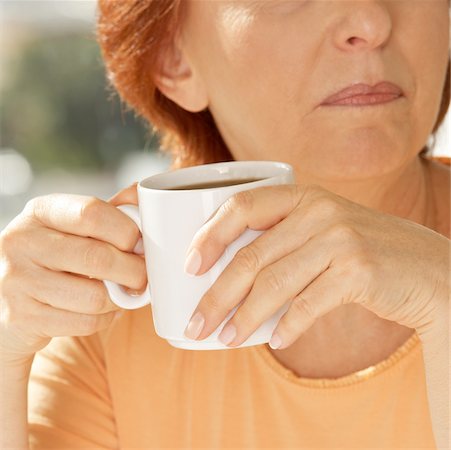 Close-up of a senior woman holding a coffee cup Stock Photo - Premium Royalty-Free, Code: 625-00902315