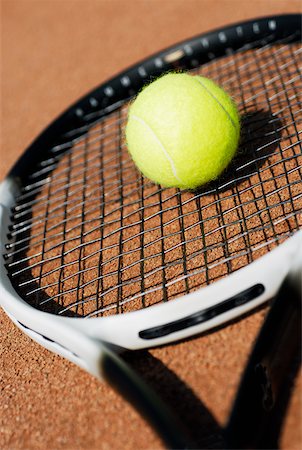 Close-up of a tennis ball on a tennis racket Stock Photo - Premium Royalty-Free, Code: 625-01037818