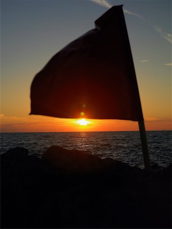 Close-up of a flag fluttering on a rock, Cartagena, Colombia Stock Photo - Premium Royalty-Free, Code: 625-01040139