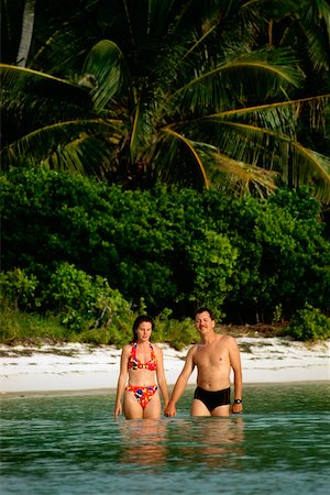 sandi model - Couple in bathing suit stand knee deep immersed in water, Abaco, Bermuda Stock Photo - Premium Royalty-Free, Code: 625-01040530