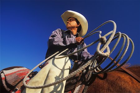 Low angle view of a cowboy riding a horse, Texas, USA Stock Photo - Premium Royalty-Free, Code: 625-01094833
