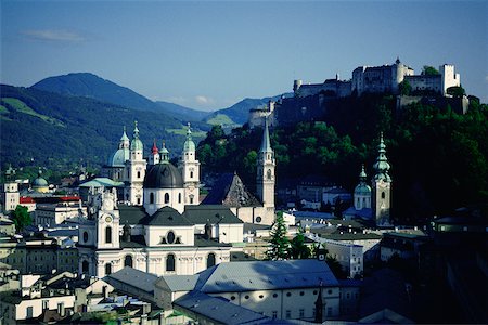 High angle view of a cathedral with a fort on top of a hill, Kollegienkirche, Hohensalzburg Fortress, Salzburg, Austria Stock Photo - Premium Royalty-Free, Code: 625-01095169