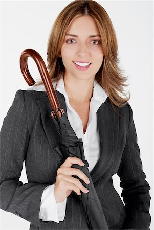 simsearch:625-01097830,k - Portrait of a businesswoman holding an umbrella and smiling Stock Photo - Premium Royalty-Free, Code: 625-01097819