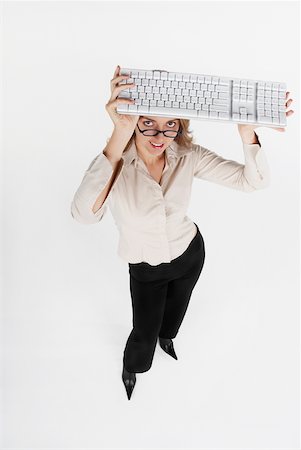 simsearch:625-01097830,k - High angle view of a businesswoman holding a computer keyboard over her head Stock Photo - Premium Royalty-Free, Code: 625-01097821