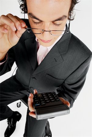 simsearch:625-01097830,k - Close-up of a businessman holding a calculator Stock Photo - Premium Royalty-Free, Code: 625-01097822