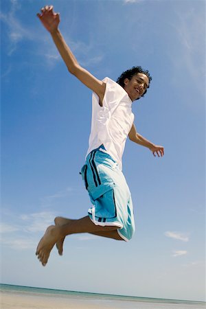 simsearch:625-01748893,k - Low angle view of a teenage boy jumping on the beach Stock Photo - Premium Royalty-Free, Code: 625-01097987