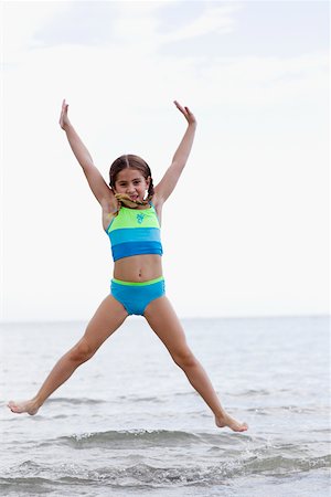 Portrait of a girl jumping on the beach Stock Photo - Premium Royalty-Free, Code: 625-01098076