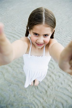 Portrait of a girl standing on the beach and smiling Stock Photo - Premium Royalty-Free, Code: 625-01098079