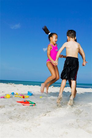 simsearch:625-02929316,k - Two girls and a boy playing on the beach Stock Photo - Premium Royalty-Free, Code: 625-01098070