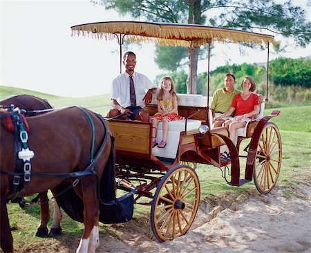 Young couple and their daughter sitting in a carriage, Bermuda Stock Photo - Premium Royalty-Free, Code: 625-01092063