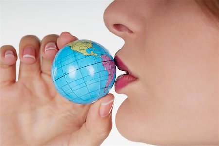simsearch:625-01097830,k - Close-up of a businesswoman kissing a globe Stock Photo - Premium Royalty-Free, Code: 625-01093707