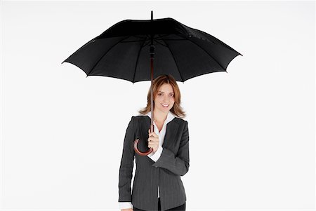 simsearch:625-01097830,k - Portrait of a businesswoman holding an umbrella and smiling Stock Photo - Premium Royalty-Free, Code: 625-01093722