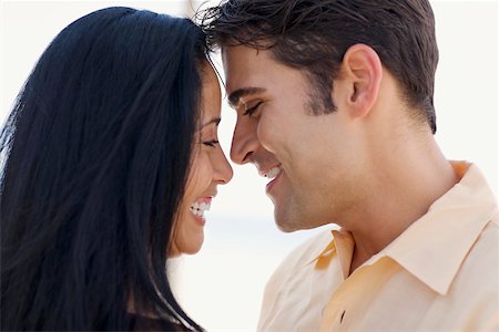 simsearch:625-00850507,k - Close-up of a young woman and a mid adult man smiling Stock Photo - Premium Royalty-Free, Code: 625-01093876