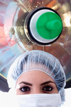 simsearch:640-01364042,k - Close-up of a female surgeon in a surgical cap and surgical mask Stock Photo - Premium Royalty-Free, Code: 625-01249629