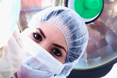 simsearch:640-01364042,k - Portrait of a female surgeon in a surgical cap and surgical mask Stock Photo - Premium Royalty-Free, Code: 625-01250058