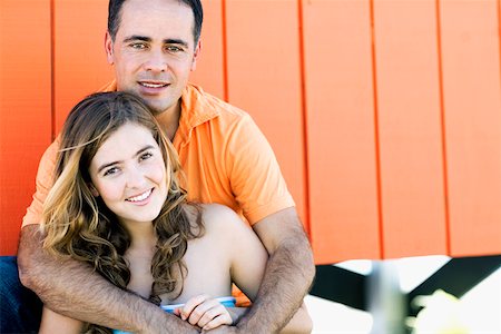 simsearch:625-00850507,k - Portrait of a mid adult man embracing a young woman from behind Stock Photo - Premium Royalty-Free, Code: 625-01250719