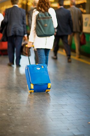 Rear view of a woman walking at a railroad station platform, Rome, Italy Stock Photo - Premium Royalty-Free, Code: 625-01251473