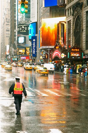 simsearch:625-00806447,k - Rear view of a traffic cop walking on the road Stock Photo - Premium Royalty-Free, Code: 625-01251529