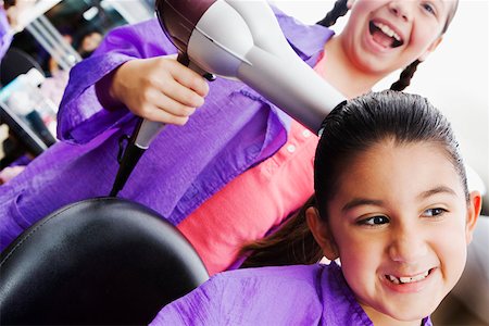 pictures of braids for a 12 year old girl - Close-up of a girl using a hair dryer on her sister Stock Photo - Premium Royalty-Free, Code: 625-01251731