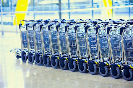 Close-up of luggage carts in a row Stock Photo - Premium Royalty-Free, Code: 625-01251788
