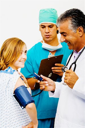 simsearch:640-01364042,k - Side profile of a male doctor measuring blood pressure of a young woman Stock Photo - Premium Royalty-Free, Code: 625-01252033