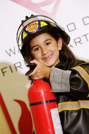 Portrait of a girl wearing a fireman costume Stock Photo - Premium Royalty-Free, Code: 625-01252095
