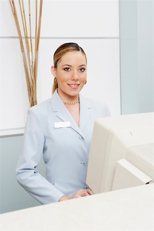Portrait of a female receptionist in front of a computer Stock Photo - Premium Royalty-Free, Code: 625-01264436