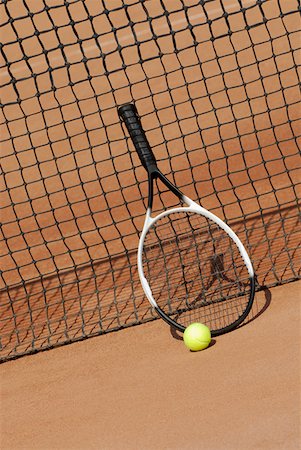 Tennis racket a tennis ball against a tennis net Stock Photo - Premium Royalty-Free, Code: 625-01264589