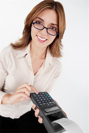 simsearch:625-01097830,k - Portrait of a businesswoman operating a credit card reader and smiling Stock Photo - Premium Royalty-Free, Code: 625-01264694