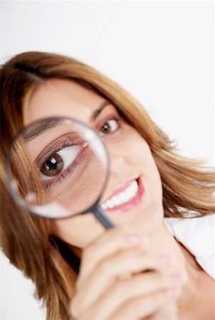 simsearch:625-01097830,k - Portrait of a businesswoman looking through a magnifying glass Stock Photo - Premium Royalty-Free, Code: 625-01260884