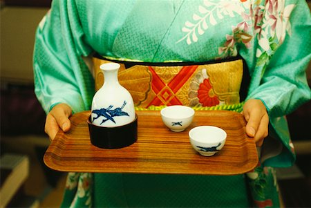 sake - Mid section view of a woman holding saki on tray, Japan Stock Photo - Premium Royalty-Free, Code: 625-01261076