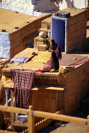 rajasthan clothes for women - Woman drying sari on the roof of a house, Jaisalmer, Rajasthan, India Stock Photo - Premium Royalty-Free, Code: 625-01261117