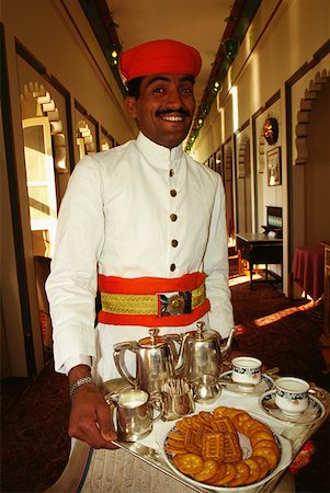 Portrait of a waiter holding a tray and smiling, Fateh Prakash Palace, Udaipur, Rajasthan, India Stock Photo - Premium Royalty-Free, Code: 625-01261383