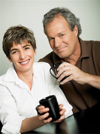 simsearch:625-01092421,k - Portrait of a mature couple holding cups of tea and smiling Stock Photo - Premium Royalty-Free, Code: 625-01261448
