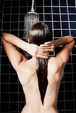 Rear view of a naked woman in the shower Stock Photo - Premium Royalty-Free, Code: 625-01261483