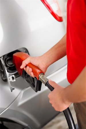 Mid section view of a man refueling a car Stock Photo - Premium Royalty-Free, Code: 625-01261509