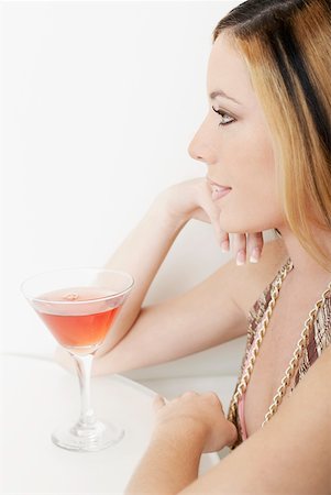 simsearch:400-04398921,k - Close-up of a young woman in front of a glass of martini Stock Photo - Premium Royalty-Free, Code: 625-01262210