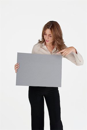 simsearch:625-01097830,k - Businesswoman pointing at a blank placard Stock Photo - Premium Royalty-Free, Code: 625-01262380