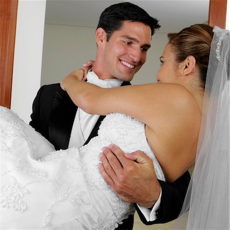 simsearch:625-01092421,k - Close-up of a groom carrying his bride and looking at each other Stock Photo - Premium Royalty-Free, Code: 625-01262636