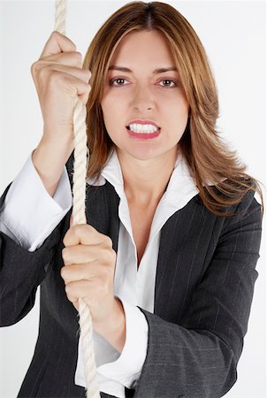 simsearch:625-01097830,k - Portrait of a businesswoman holding a rope and clenching her teeth Stock Photo - Premium Royalty-Free, Code: 625-01262679