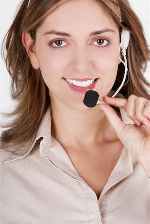 simsearch:625-01097830,k - Portrait of a female customer service representative talking on a headset and smiling Stock Photo - Premium Royalty-Free, Code: 625-01262818