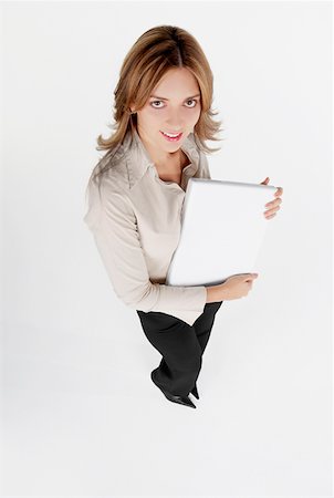 simsearch:625-01097830,k - High angle view of a businesswoman holding a laptop and smiling Stock Photo - Premium Royalty-Free, Code: 625-01263339