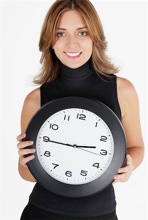 simsearch:625-01097830,k - Portrait of a businesswoman holding a clock and smiling Stock Photo - Premium Royalty-Free, Code: 625-01263408